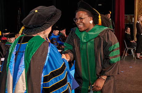 an image of students shaking hands