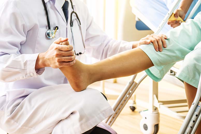 An orthopaedic surgeon examining a leg