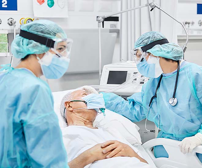Surgeons check on an elderly patient prior to a procedure.