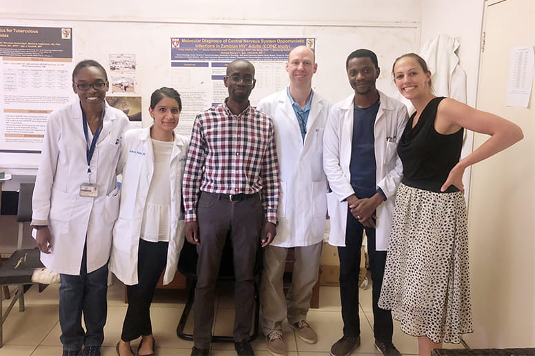 The Geisinger team of Ashka Patel, DO (second from left), Christopher Cummings, MD (third from right) and Kelly Baldwin, MD (far right), interact with Zambian neurology residents at University Teaching Hospital in Lukasa.