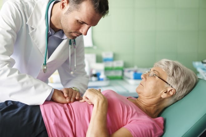 an image of a doctor checking a patients stomach