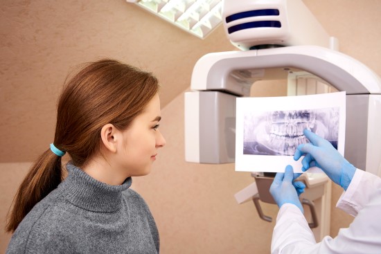 an image of a dental patient looking at a xray