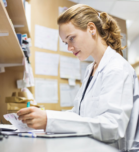an image of a pharmacist looking at a prescription