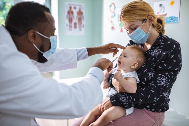 an image of a doctor checking a baby