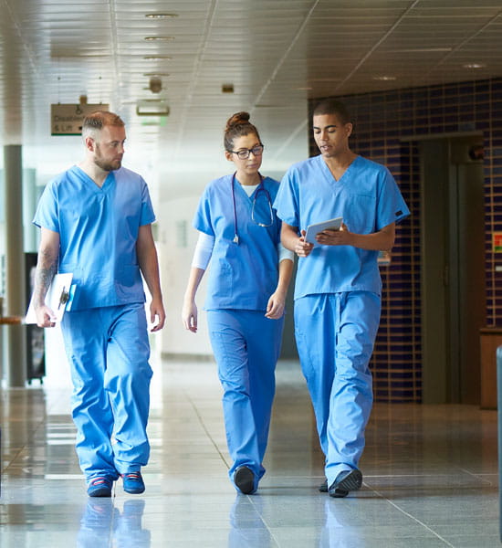 an image of resident students walking in a hospital hallway