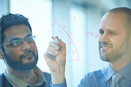 Two men at see-through white board