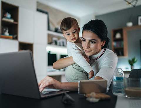 A woman and her young son at a laptop